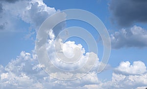 Beautiful fluffy clouds on light blue sky as background