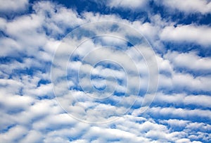 Beautiful fluffy white clouds on blue sunny sky as background