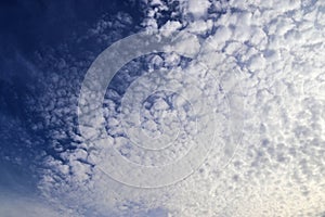 Beautiful fluffy white clouds in a deep blue sky on a summer day