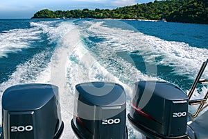 A beautiful foamy trail from a boat with three powerful engines, leaving from Banana Beach of Coral Koh He Island, Thai