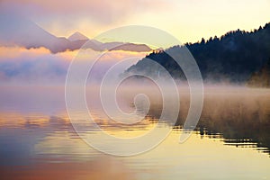 Beautiful foggy sunrise the Bled lake on autumn
