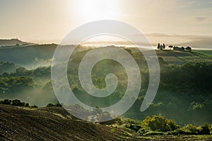 Beautiful foggy sunrise landscape in Tuscany, Italy