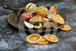 Beautiful food portrait of Wnter seasonal dried fruits with old vintage texture background and cutlery and accessories