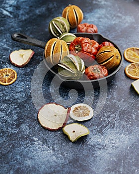 Beautiful food portrait of Wnter seasonal dried fruits with old vintage texture background and cutlery and accessories