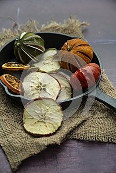 Beautiful food portrait of Wnter seasonal dried fruits with old vintage texture background and cutlery and accessories