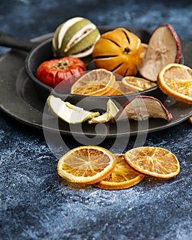 Beautiful food portrait of Wnter seasonal dried fruits with old vintage texture background and cutlery and accessories