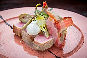 Beautiful food: steak tuna in sesame, lime and fresh salad close-up on a plate