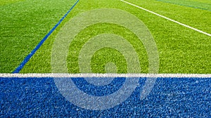 Beautiful Football field. White and blue lines on green artificial grass of a football field