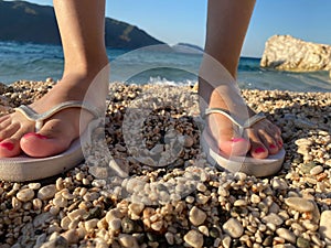 Beautiful foots of young woman wearing in flip flops