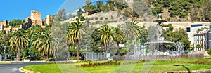 Beautiful fountain and panoramic view of Alcazaba fortress wall in Malaga. Andalusia, Spain