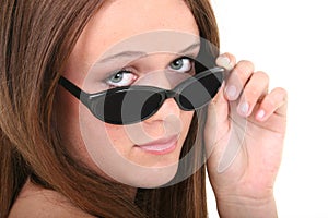 Beautiful Fourteen Year Old Girl Looking Over Sunglasses photo