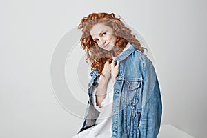 Beautiful foxy girl smiling looking at camera posing over white background.