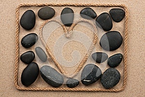 Beautiful frame of rope in the form of heart with black stones