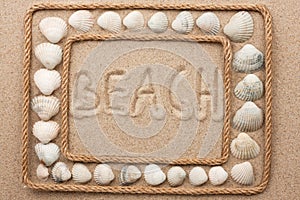 Beautiful frame of rope and seashells on the sand with inscription beach