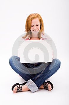 Beautiful freckled teen with computer photo