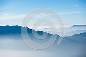 Beautiful french alps winter panoramic aerial view landscape with a fantastic blue haze cloudy mountain background