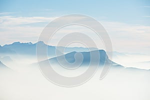 Beautiful french alps winter panoramic aerial view landscape with a fantastic blue haze cloudy mountain background