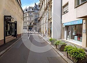 Beautiful French woman walking bulldog on the almost empty street in Strasbourg