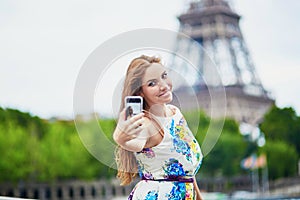 Beautiful French woman walking near the Eiffel tower