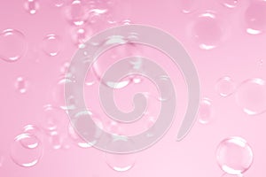 Beautiful fresh soap bubbles floating on pink background