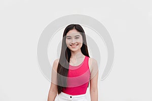 A beautiful and friendly female freshman college student in a pink sleeveless blouse smiling. Isolated on a white background