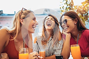 Beautiful friends in a cafe having fun