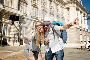 Beautiful friends tourist couple visiting Spain in holidays students exchange taking selfie picture