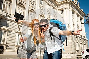 Beautiful friends tourist couple visiting Spain in holidays students exchange taking selfie picture