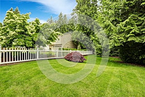 Beautiful front yard landscape with white fence