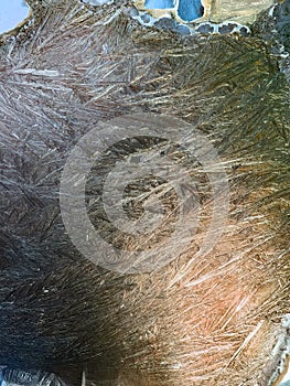 Beautiful frostwork on a window glass as an abstract winter background blue white ice stripes, frost pattern