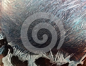 Beautiful frostwork on a window glass as an abstract winter background blue white ice stripes, frost pattern