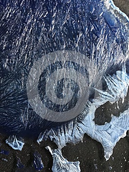 Beautiful frostwork on a window glass as an abstract winter background blue white ice stripes, frost pattern, hoarfrost. For