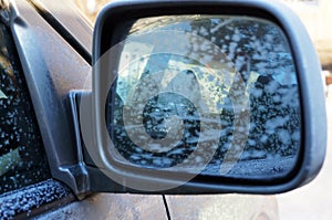 Beautiful frosty patterns in the rearview mirror on the glass of the car