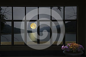 Beautiful full moon over the river in window view