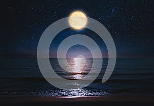 Beautiful full moon in starry sky over sea at night