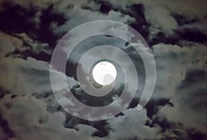 Beautiful full moon and white cloudy sky background in the midnight sky background, moonlight on Halloween night without stars.