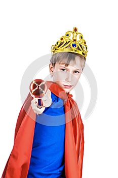 Beautiful funny child dressed as king wearing a crown commanding