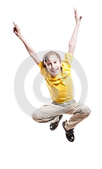 Beautiful funny child in yellow t-shirt jumping in excitement and laughing