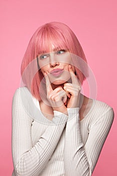 Beautiful funny cute woman in pink wig and classic makeup. Beauty face.