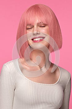 Beautiful funny cute woman in pink wig and classic makeup. Beauty face.
