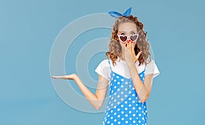 Beautiful funny girl on colored blue background