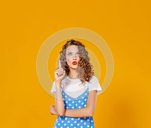 Beautiful funny girl on colored yellow background