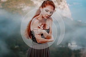 Beautiful furious scandinavian warrior ginger woman in grey dress