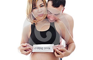 Beautiful future parents: his pregnant asian wife and a happy husband welcome baby coming soon