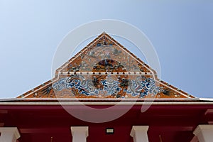 ?Beautiful gable of the church is decorated with stucco and ceramic designs in the temple ?Bangkok