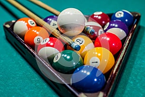 beautiful game of colored layers on a green table with holes and table lamps.