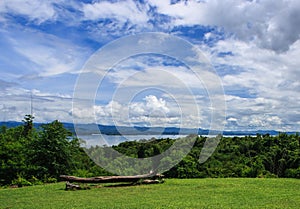 Beautiful garden in front of blue Srinakarin dam with clear blue sky, Kanchanaburi province, Thailand