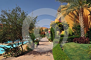 Beautiful garden at hotel resort and building in traditional arabic style. Resort architecture in Egypt