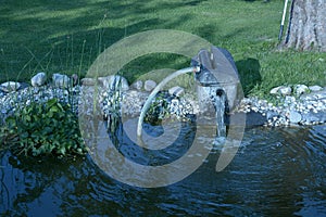 Beautiful garden pond with outdoor electric water pump