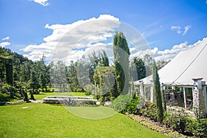 Beautiful garden of the quebrada xela with trees and flowers and event house with blue sky